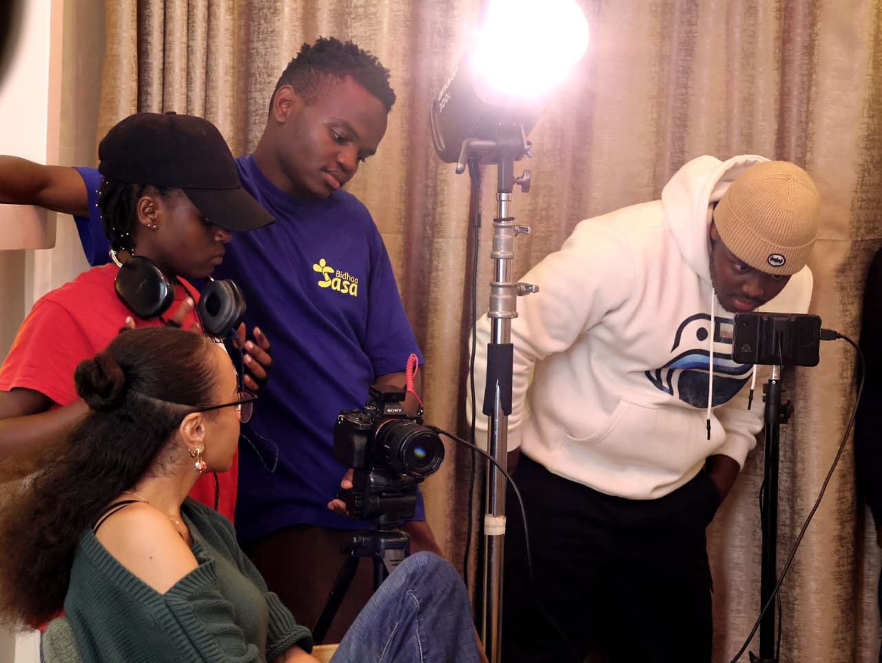 A Regal Films crew preparing a camera and lighting setup on set